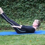 woman doing pilates hundred outside